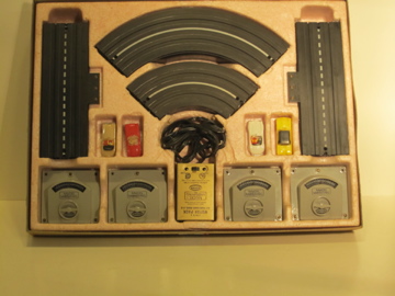 CONTENTS OF THE HO SCALE VIBRATOR 4 LANE SET. CORVETTE, JAGUAR XK140, MERCEDES 300SL, & FORD T BIRD.