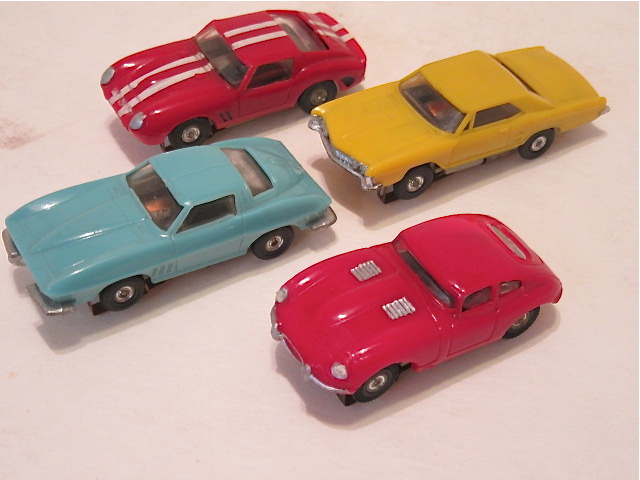 4 HO SCALE CARS FROM THE 4 LANE SET, RED FERRARI 250 GTO, YELLOW BUICK RIVERA, BLUE CORVETTE STINGRAY, & A RED JAGUAR XKE. RARE