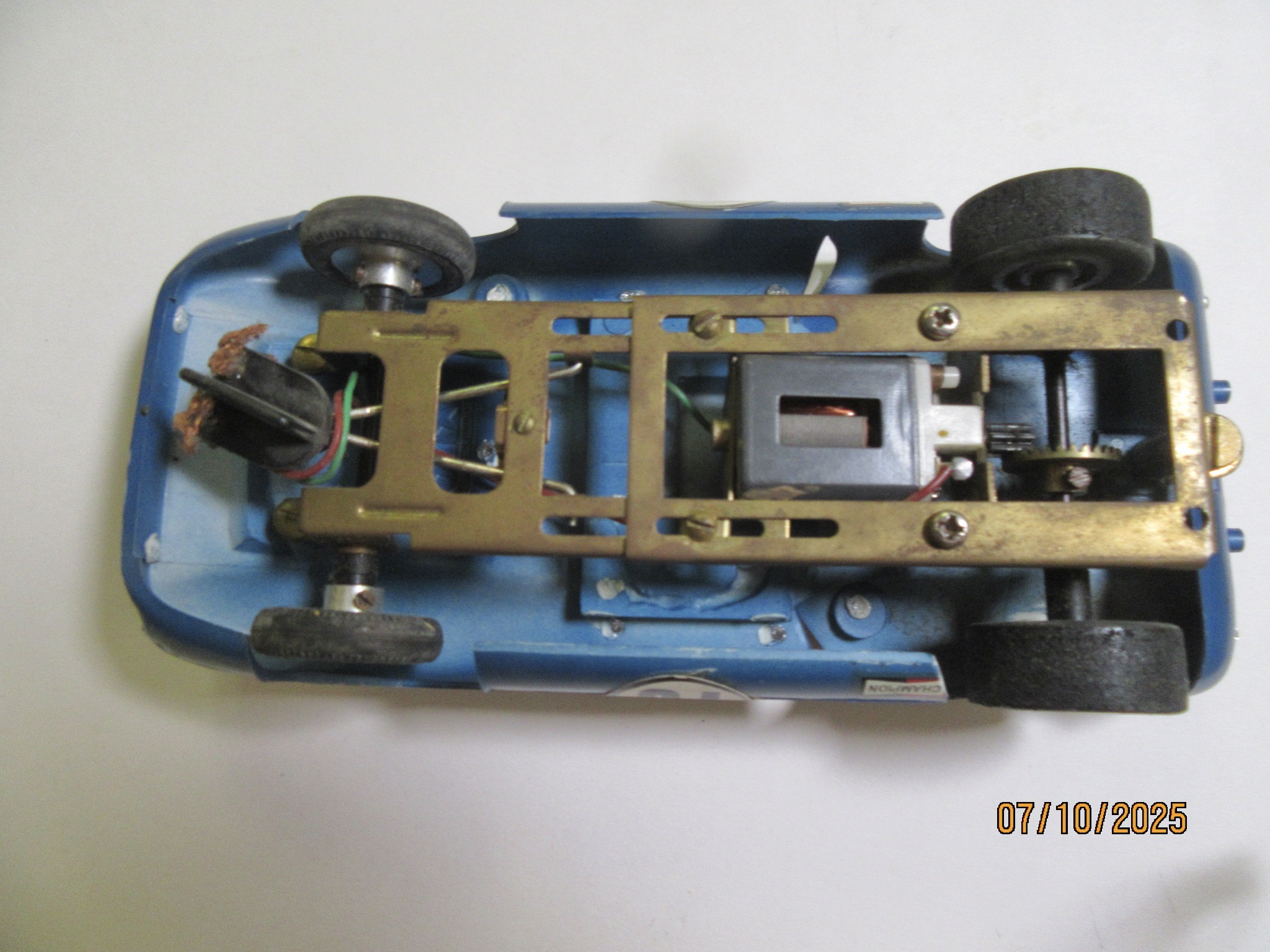 BRASS CHASSIS FOR THE 1/24TH SCALE LOLA T70 SET CARS, YOU CAN SEE THE OVER SPRAY FROM THE FACTORY PAINT JOB. RARE