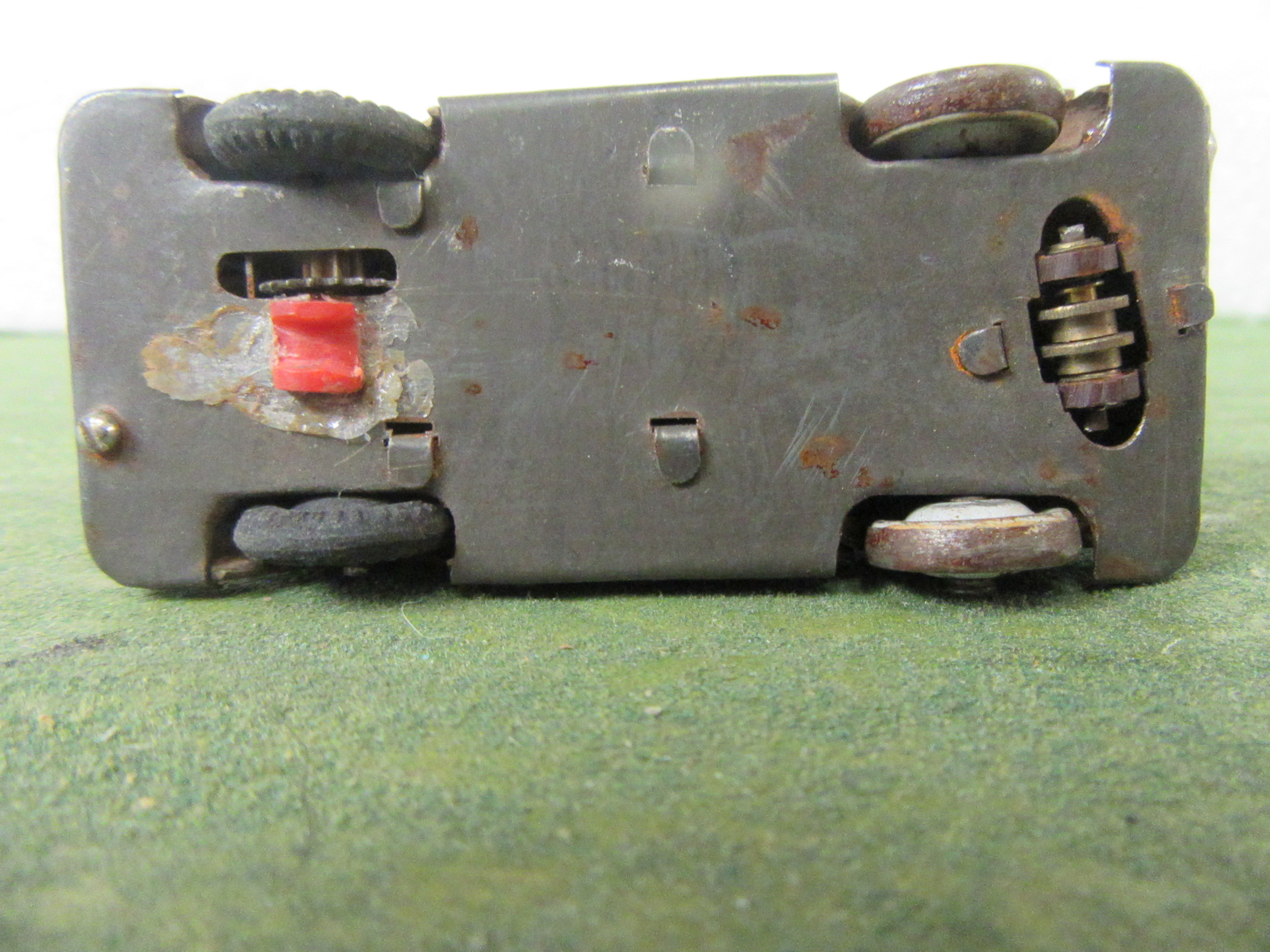METAL BASE OF THE 1/43RD SCALE FIRETRUCK SHOWING THE UNUSUAL GUIDE 