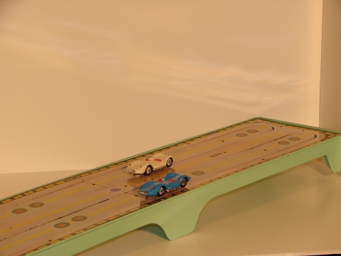 BATTERY OPERATED TRACK MOVES THE CARS IN EITHER DIRECTION . THE TRACK IS TINPLATE,  1963