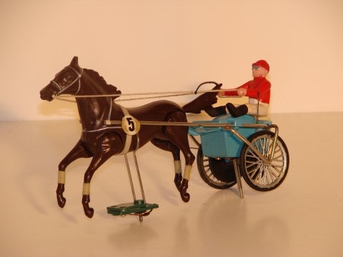 SULKY WITH THE HORSES LEGS MOVING.