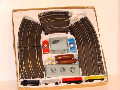 1/43RD SCALE SET SHOWING THE TRAIN TRACK ON THE OUTER LANE OF THE SLOT TRACK.