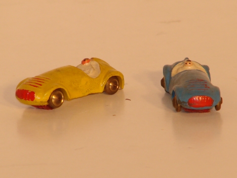 1950S VIBRATOR CARS MADE OF COMPOSTION WITH METAL WHEELS.