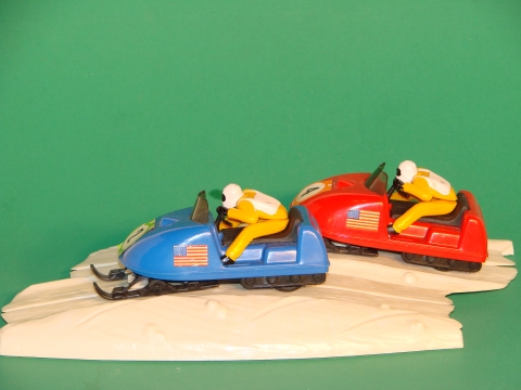 2 SNOWMOBLIES ON SNOW TRACK